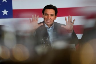 Ron DeSantis speaking at political event in front of a US flag