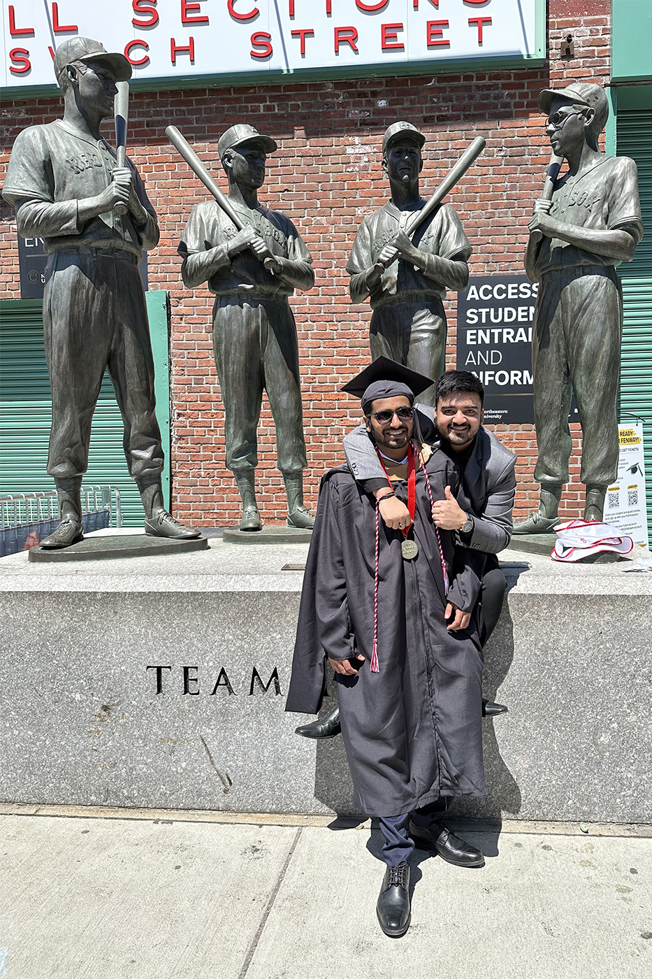 Pulkit and Hardik posing for a photo outside of Fenway park