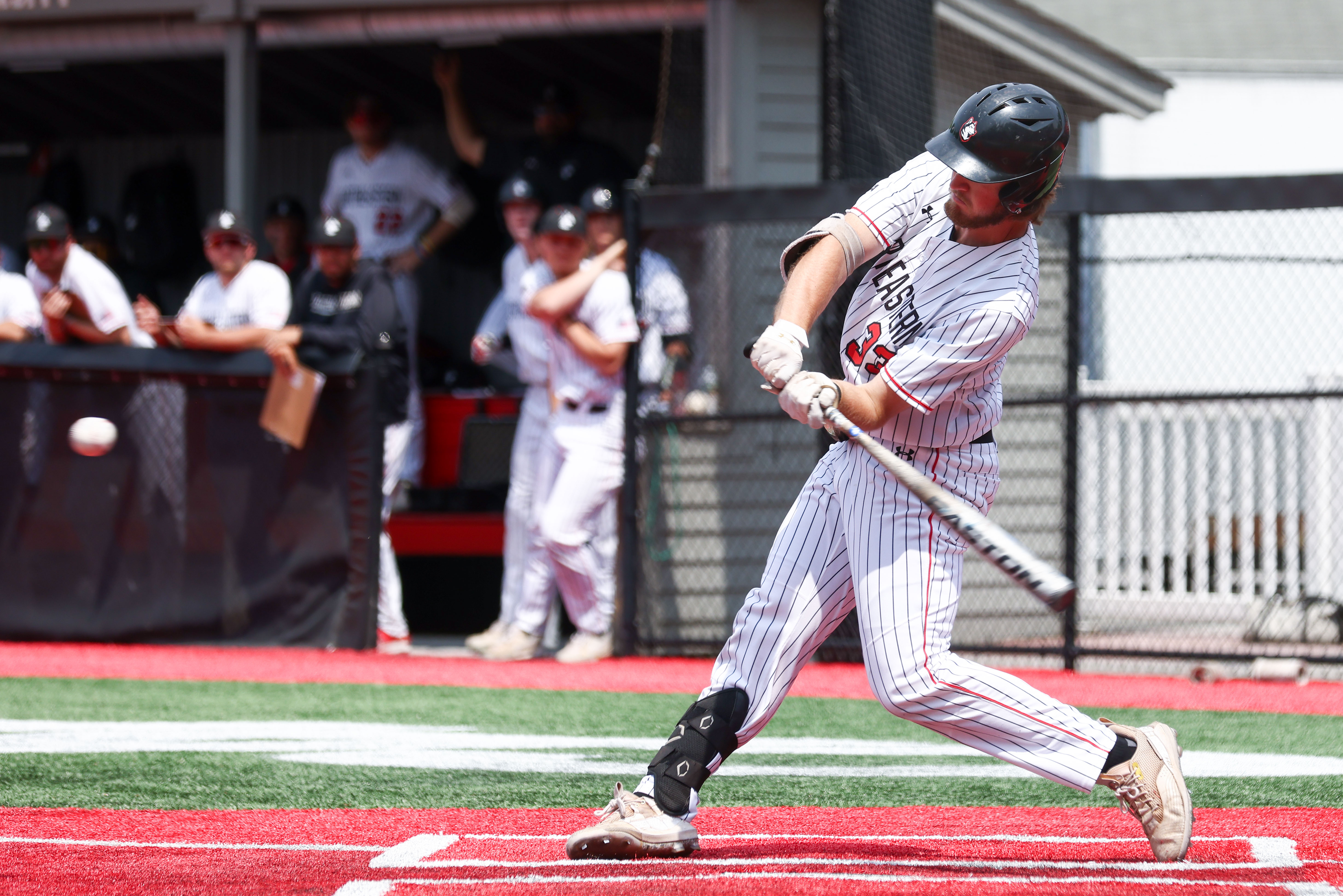 A left-handed hitter swings at a pitch.