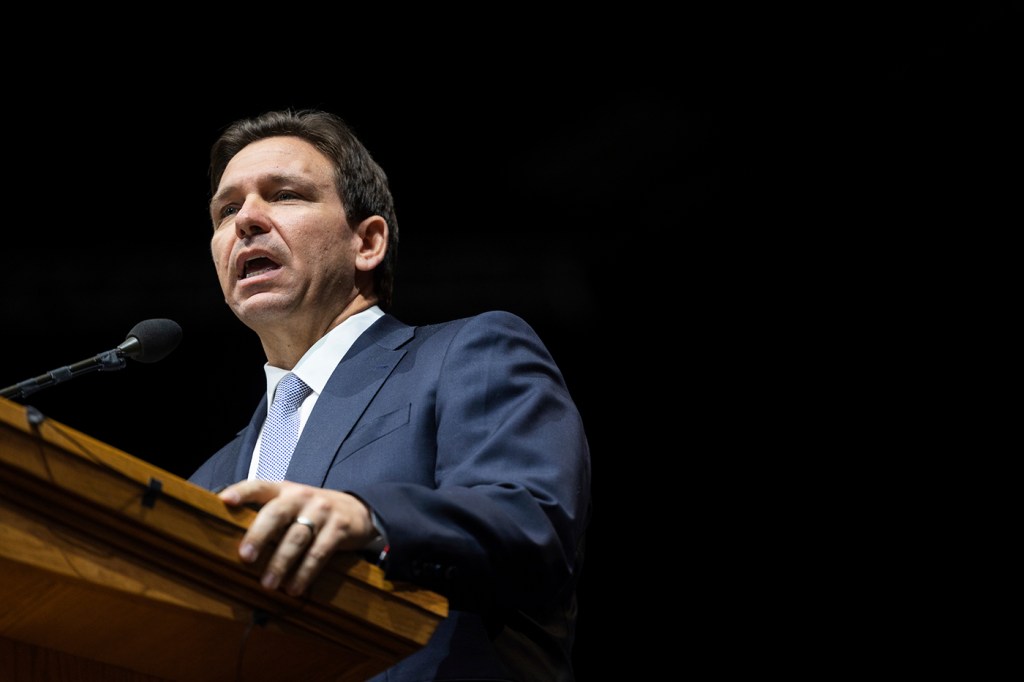 Ron DeSantis speaking in front of a microphone