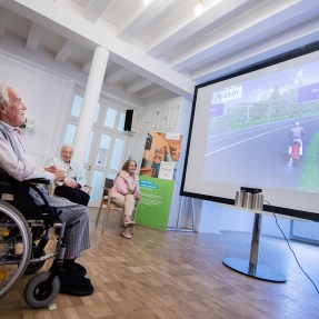 older person playing a video game on a monitor