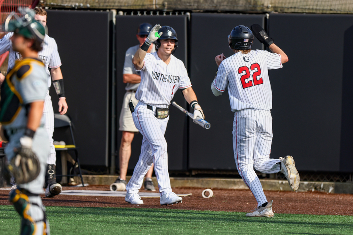 Spenser Smith running to high five another Huskies player