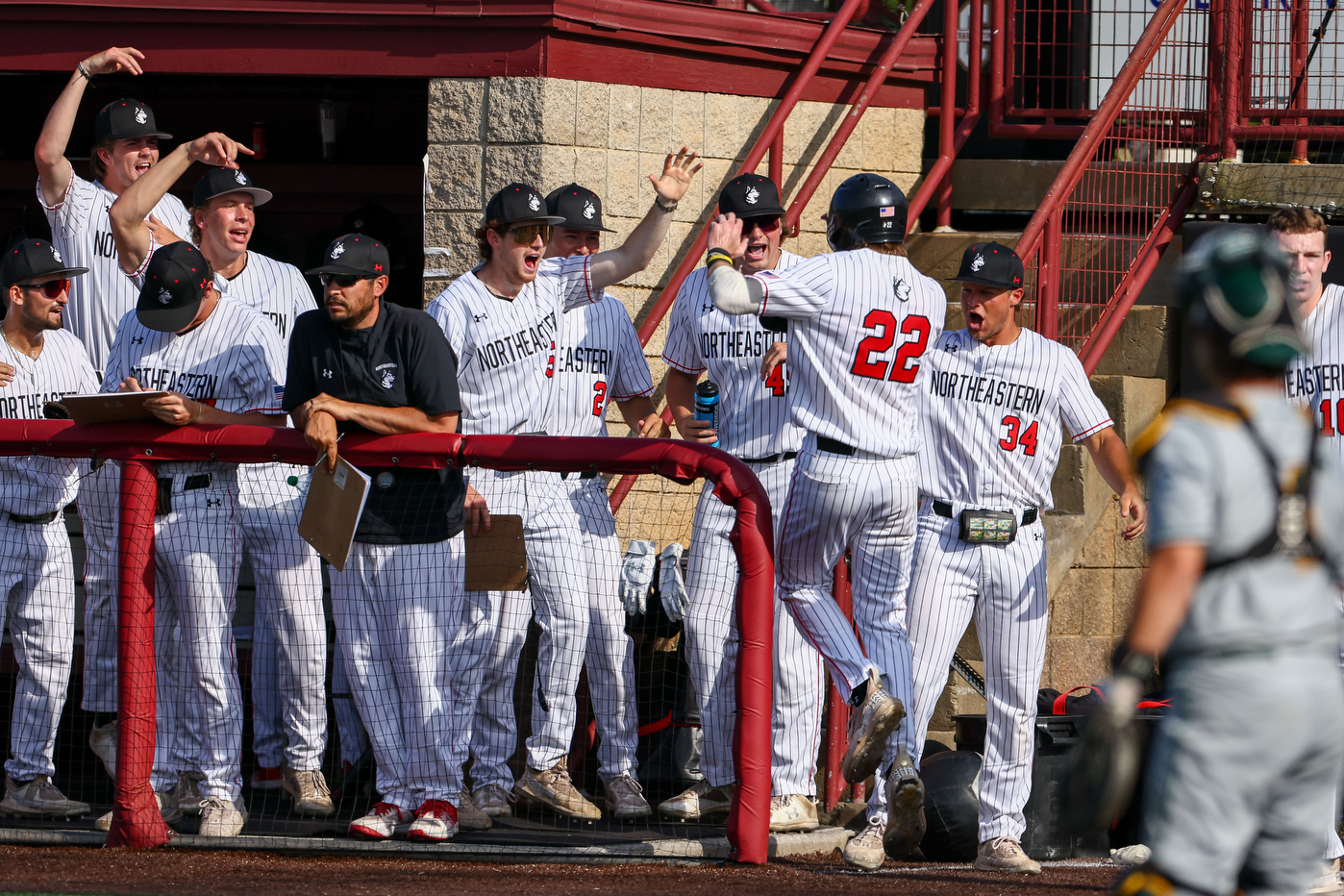 Baseball players celebrate in dugout