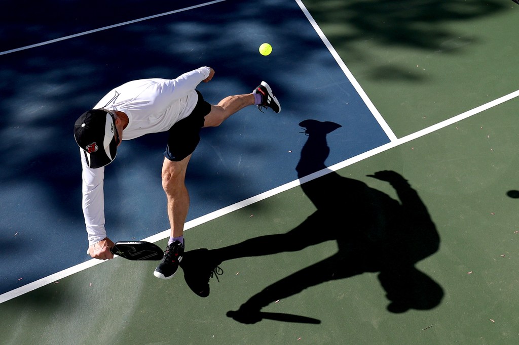 person playing pickleball outside