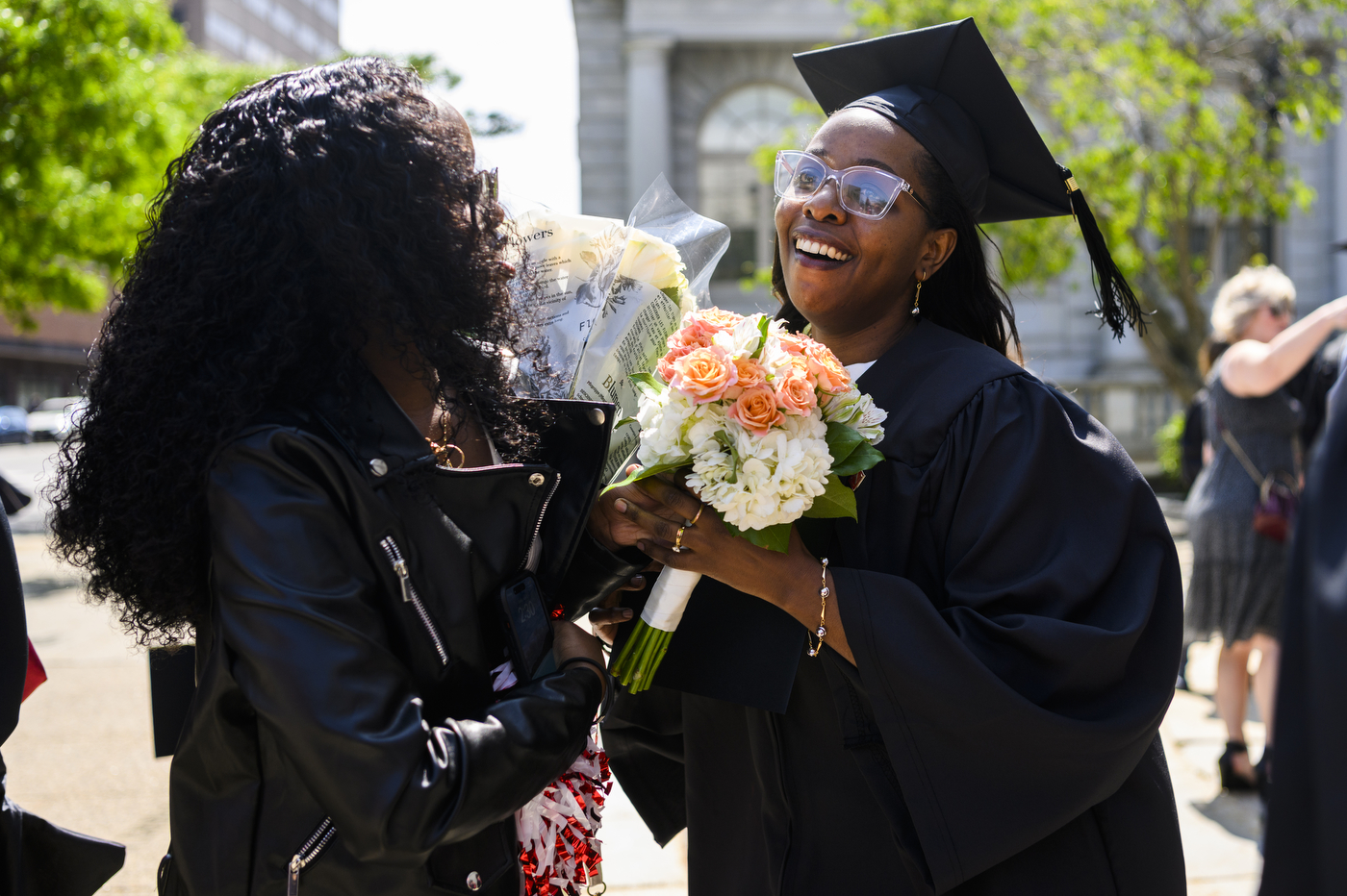 graduates hugging each other