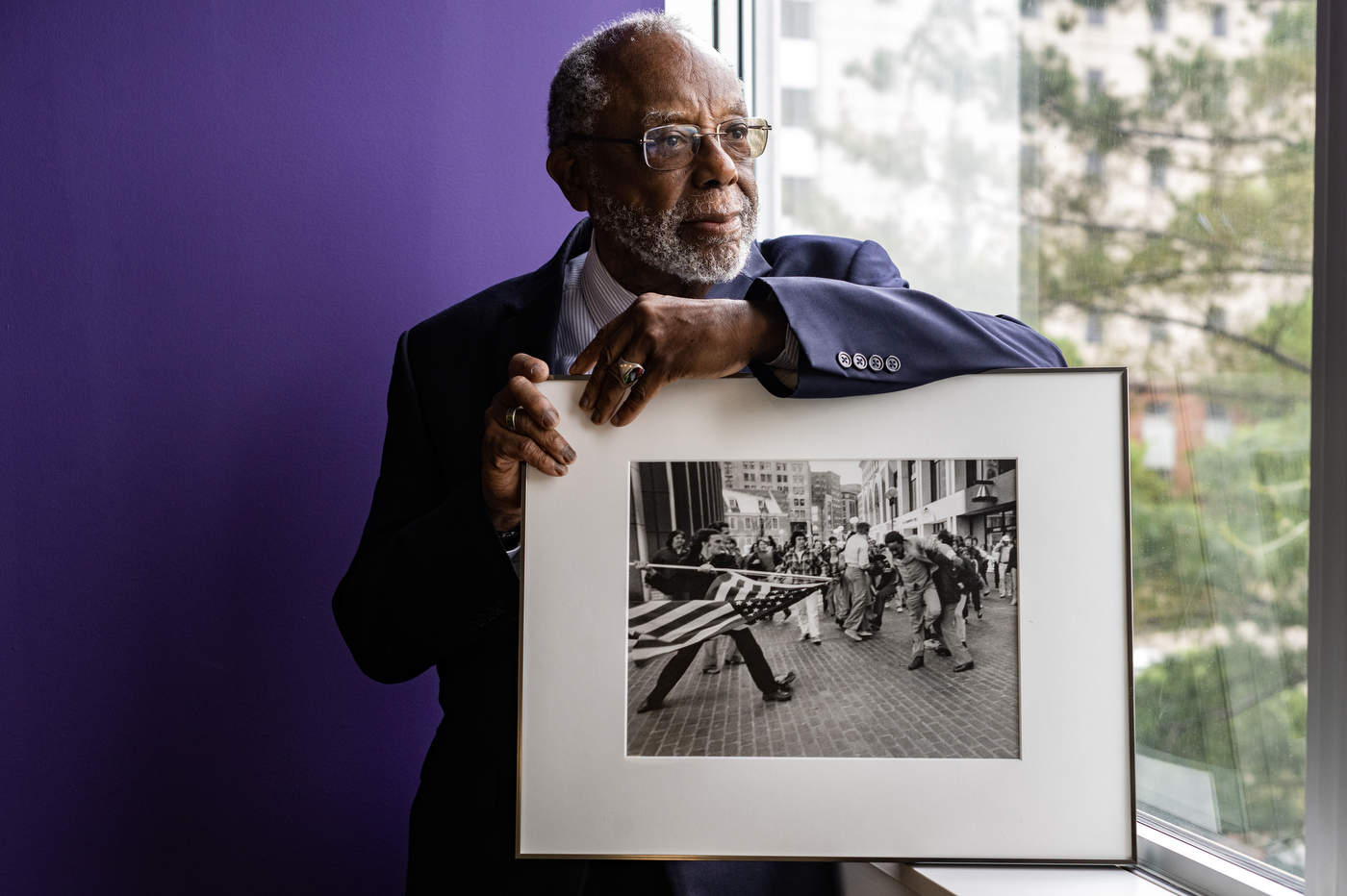 Ted Landsmark holding photograph of The Soiling of Old Glory