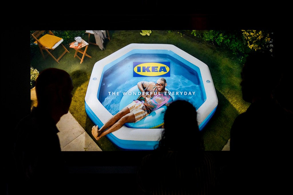 A person lounging in an inflatable pool on the screen