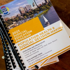 A stack of Salus Populi 2023 Judicial Education Program booklets