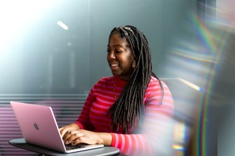 Adebukola Ajao, owner of BDY Consult marketing agency, working on her laptop