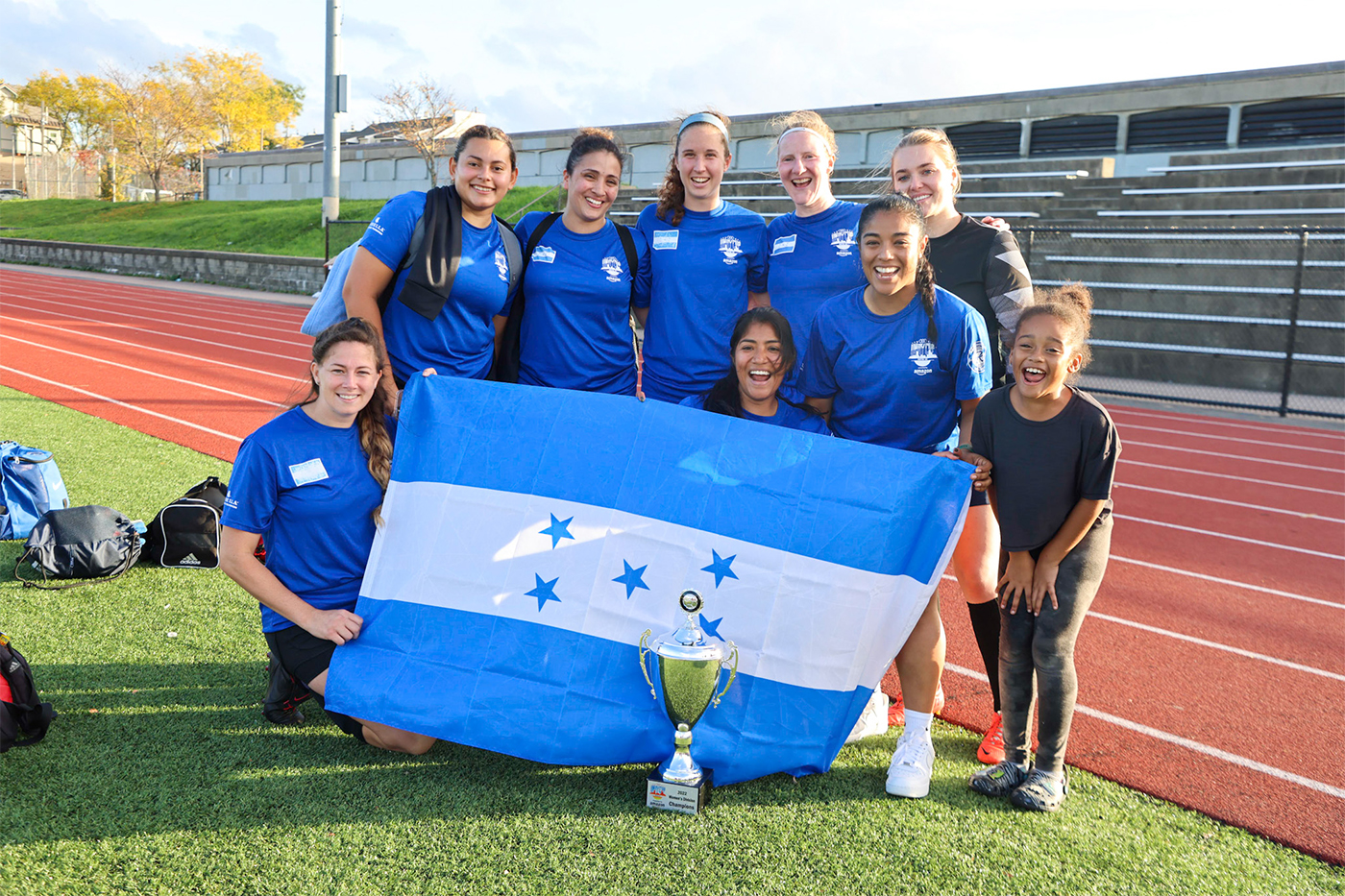 team posing with a flag