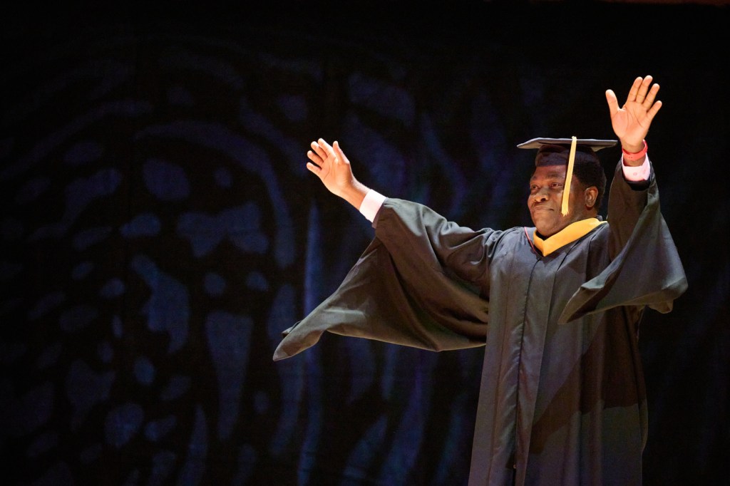 Emmanuel Nasamu with his hands raised in the air