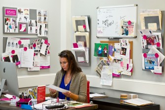 Jenny Greer working on her laptop in her office