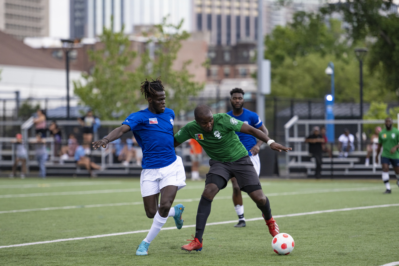 soccer players challenging for the ball