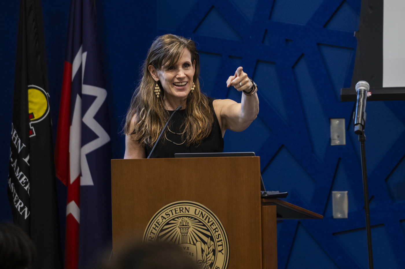 person speaking in front of microphone at the Summer Youth Jobs Program