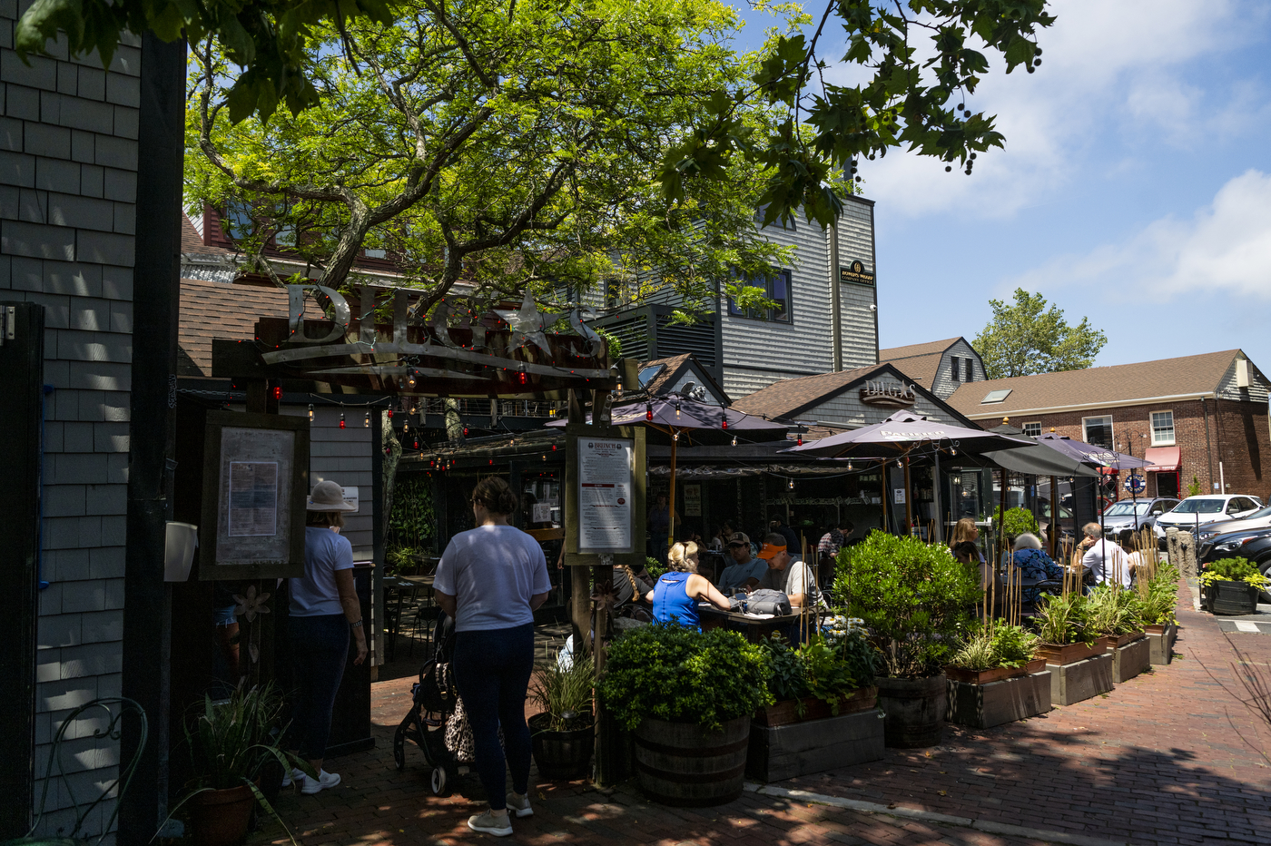 people eating on the front patio of Scott Kirmil's restaurant