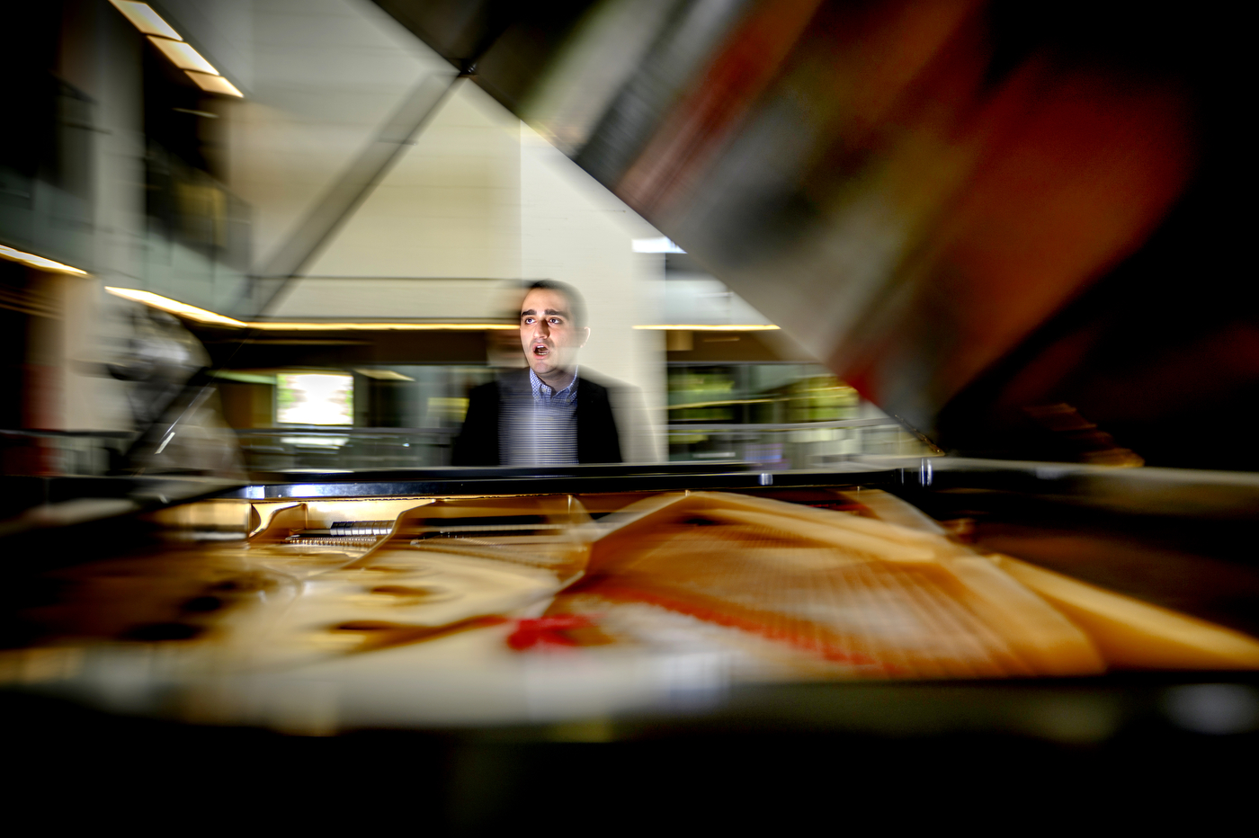 Andrew Andraos playing the piano and singing