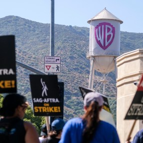 striking writers and actors outside Warner Bros Studios in California