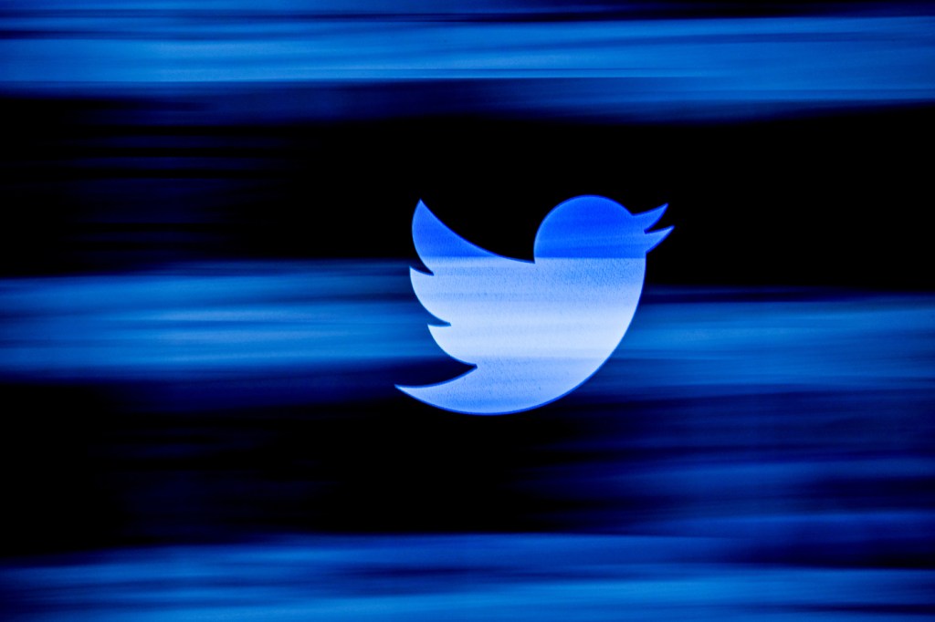 blue twitter logo on black background