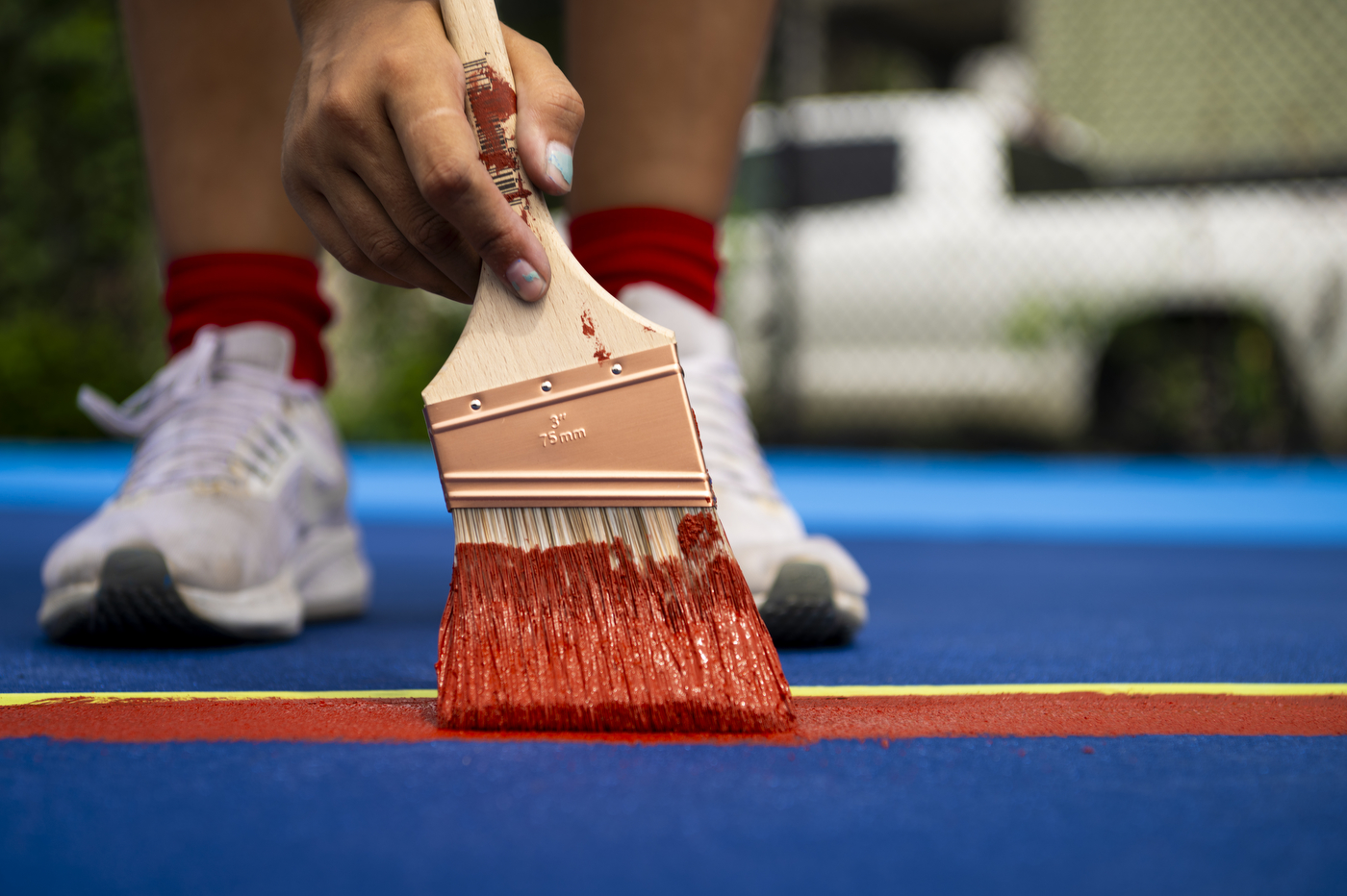 Kaiya Santos painting with red paint