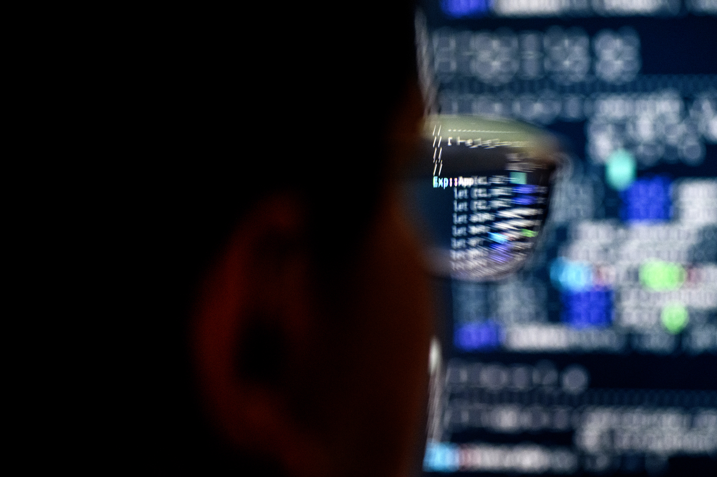 A person looks at code on a computer screen.