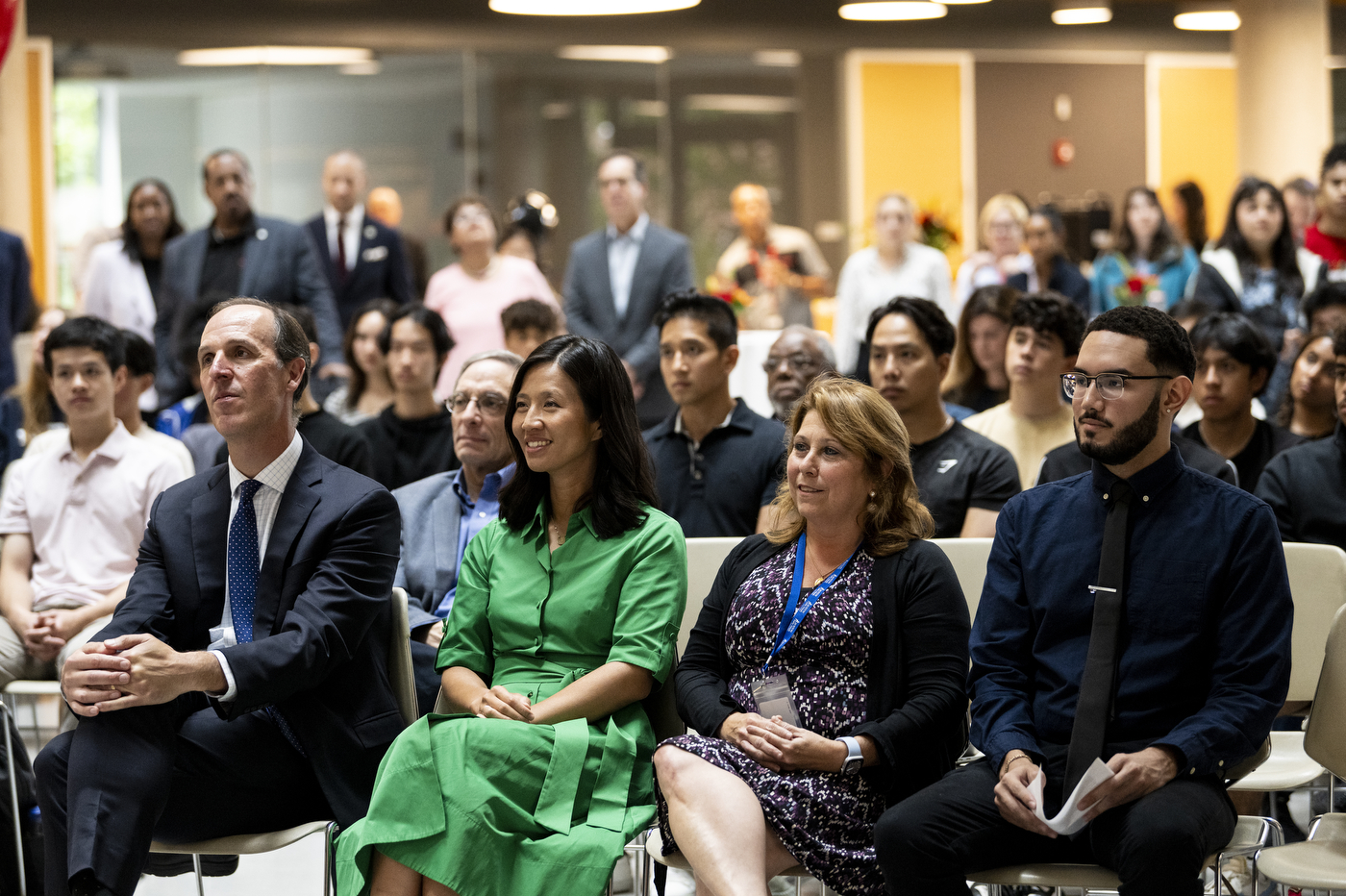 Mayor Michelle Wu sitting next to Michael Armini and two others