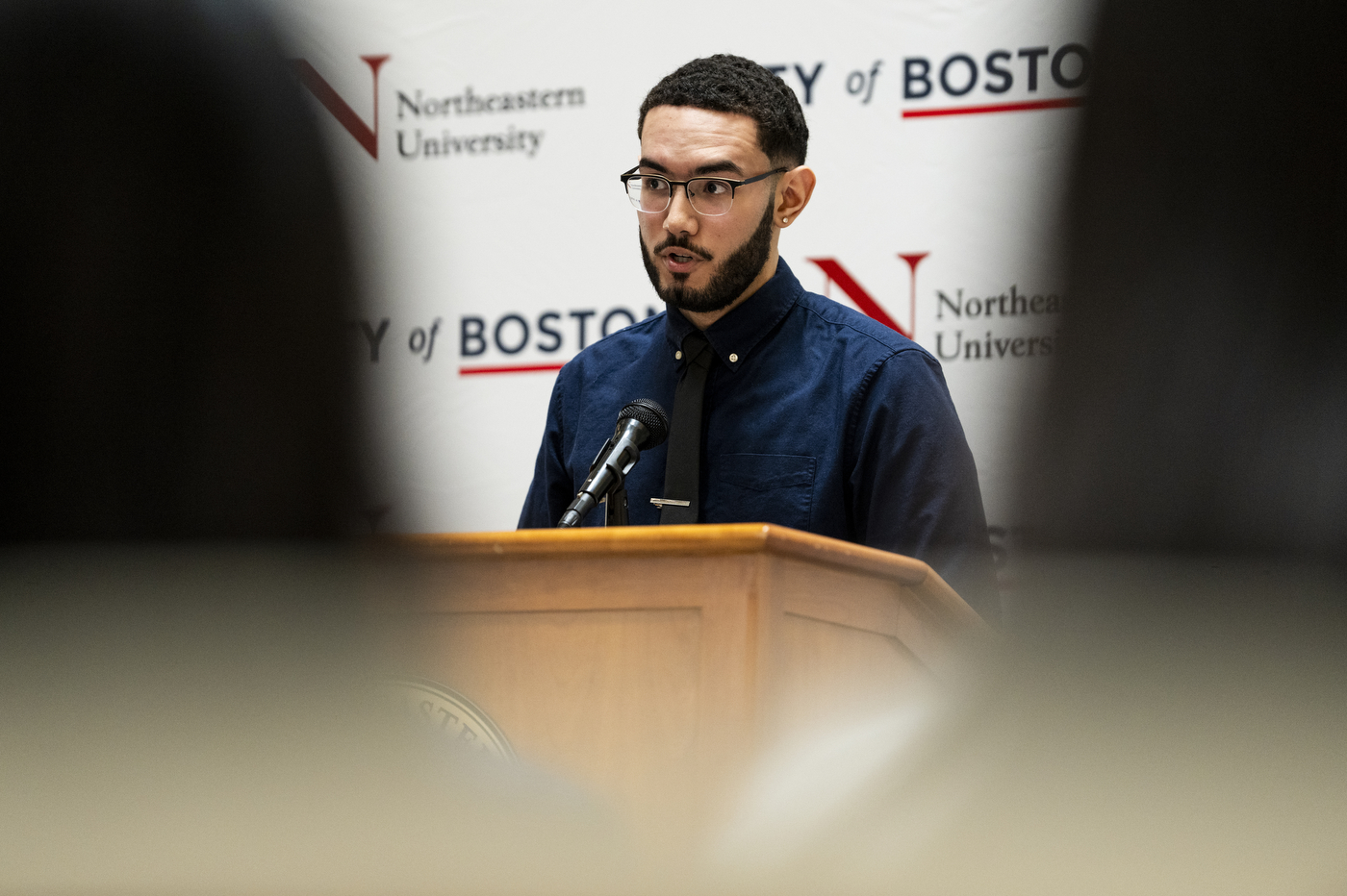 John Dume Pimentel speaking into microphone