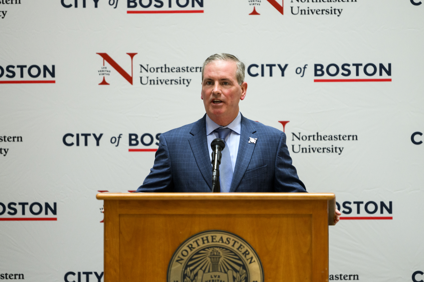 John Tobin speaking in front of microphone