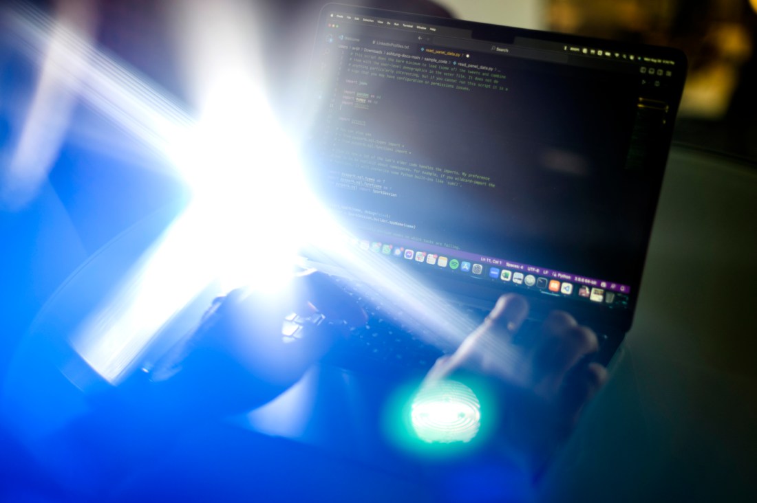 Dr. Avijit Ghosh writing code on his laptop