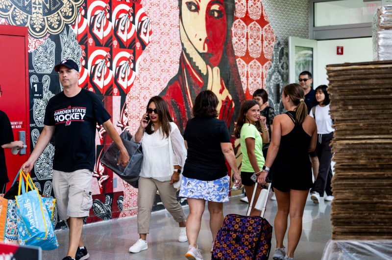 students and their family members walking with bags and suitcases