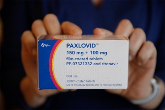 person holding box of Paxlovid