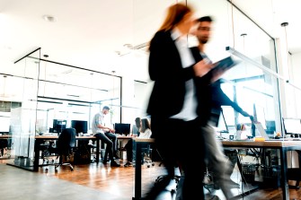 time lapse photo of people walking through an office