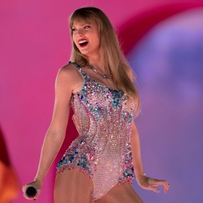 Taylor Swift performing during the Eras tour in a bedazzled bodysuit