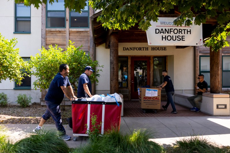 students pushing move in carts