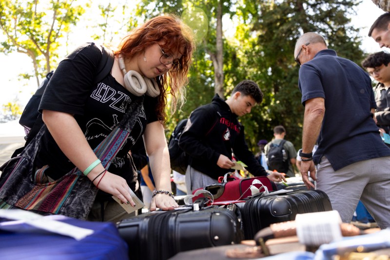 students tagging luggage