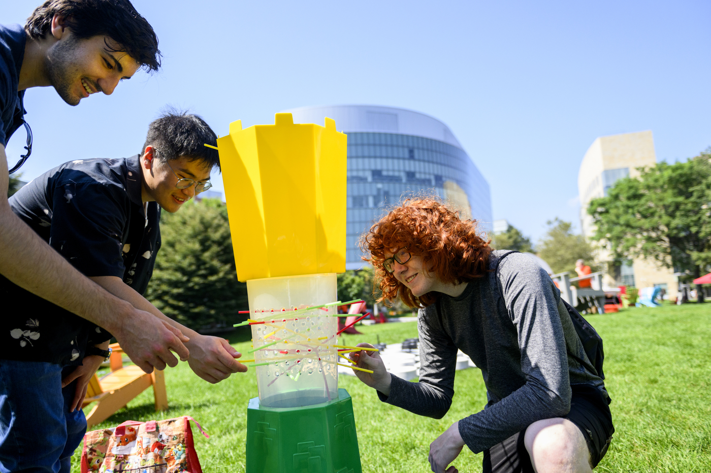 Three people play KerPlunk at Northeastern’s Welcome Week.