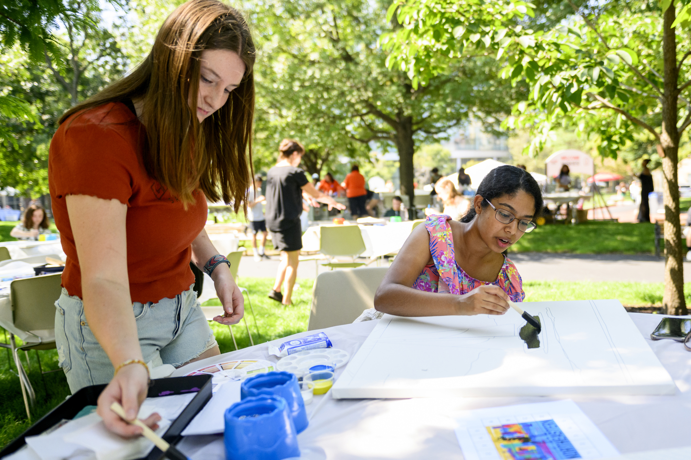 Two people paint at Northeastern’s Welcome Week.