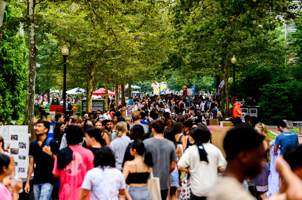 People walk around outside at Fall Fest.