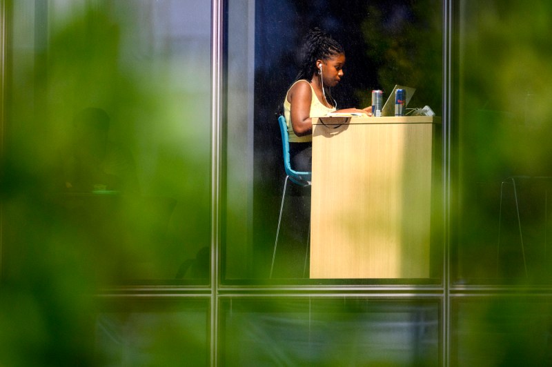 student working on their laptop inside