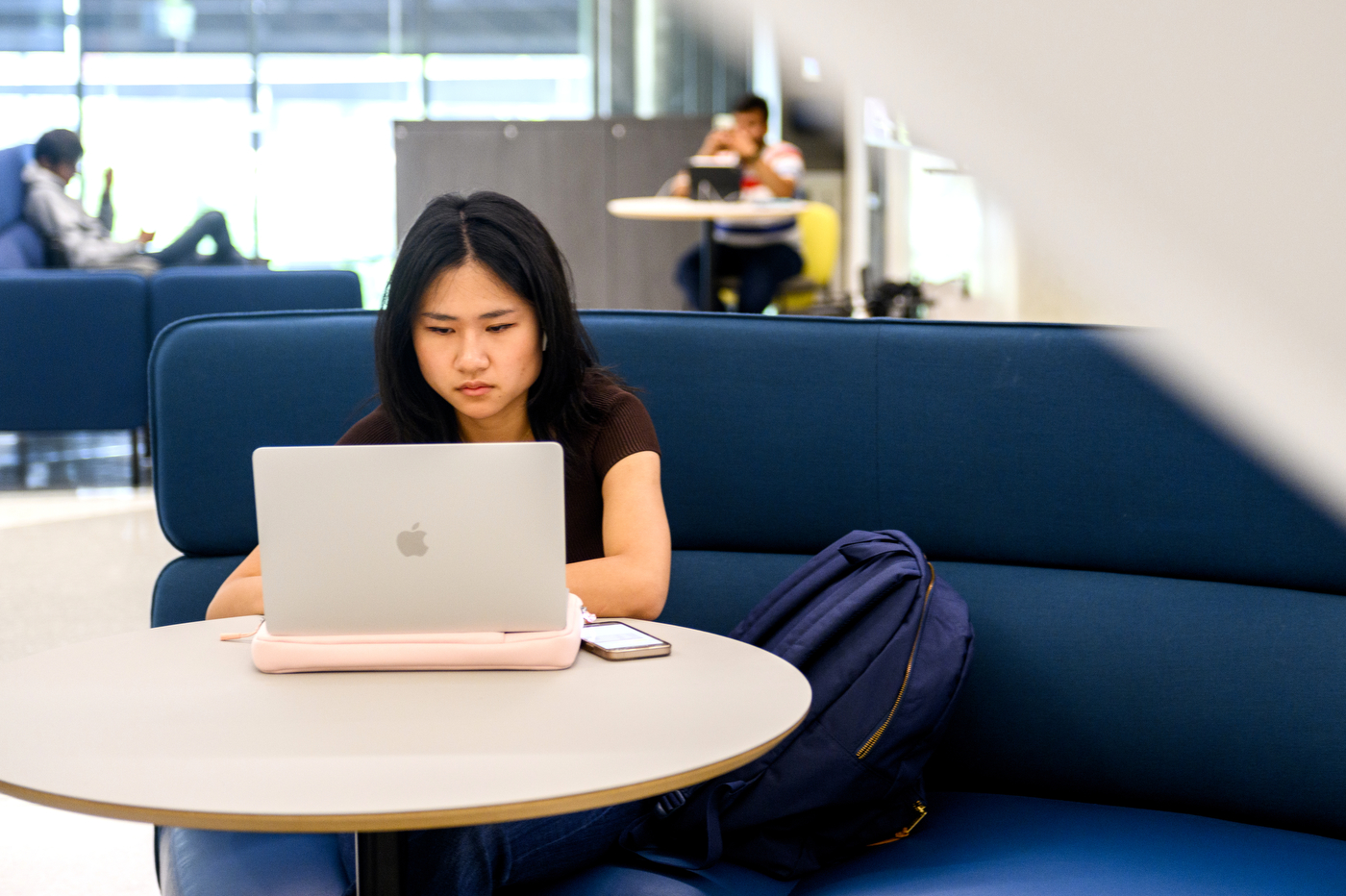 student working on their laptop inside of EXP