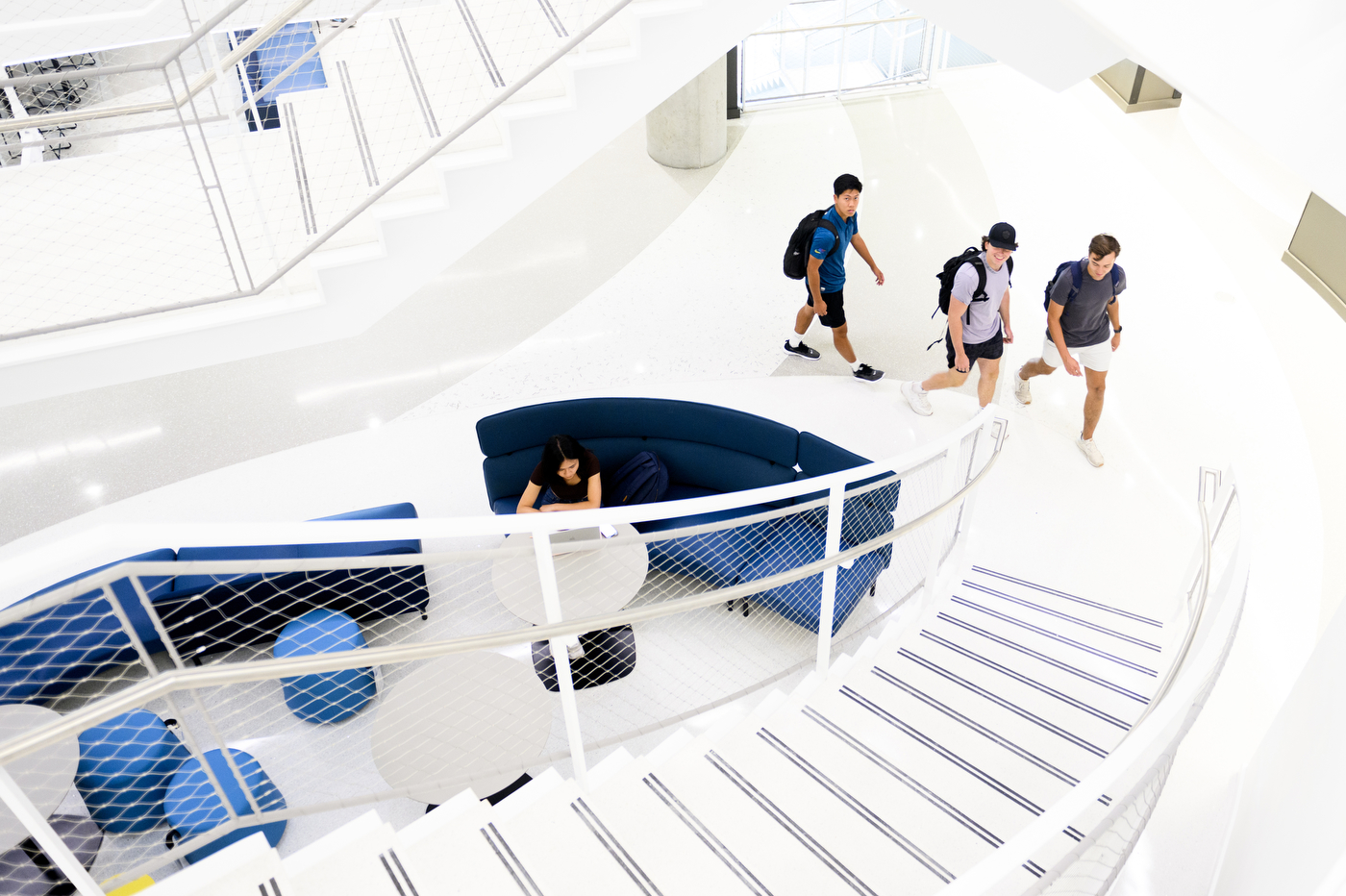 three students approaching the staircase in EXP