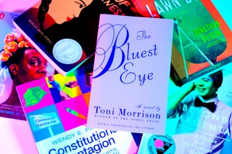 stack of books with a book called The Bluest Eye on top