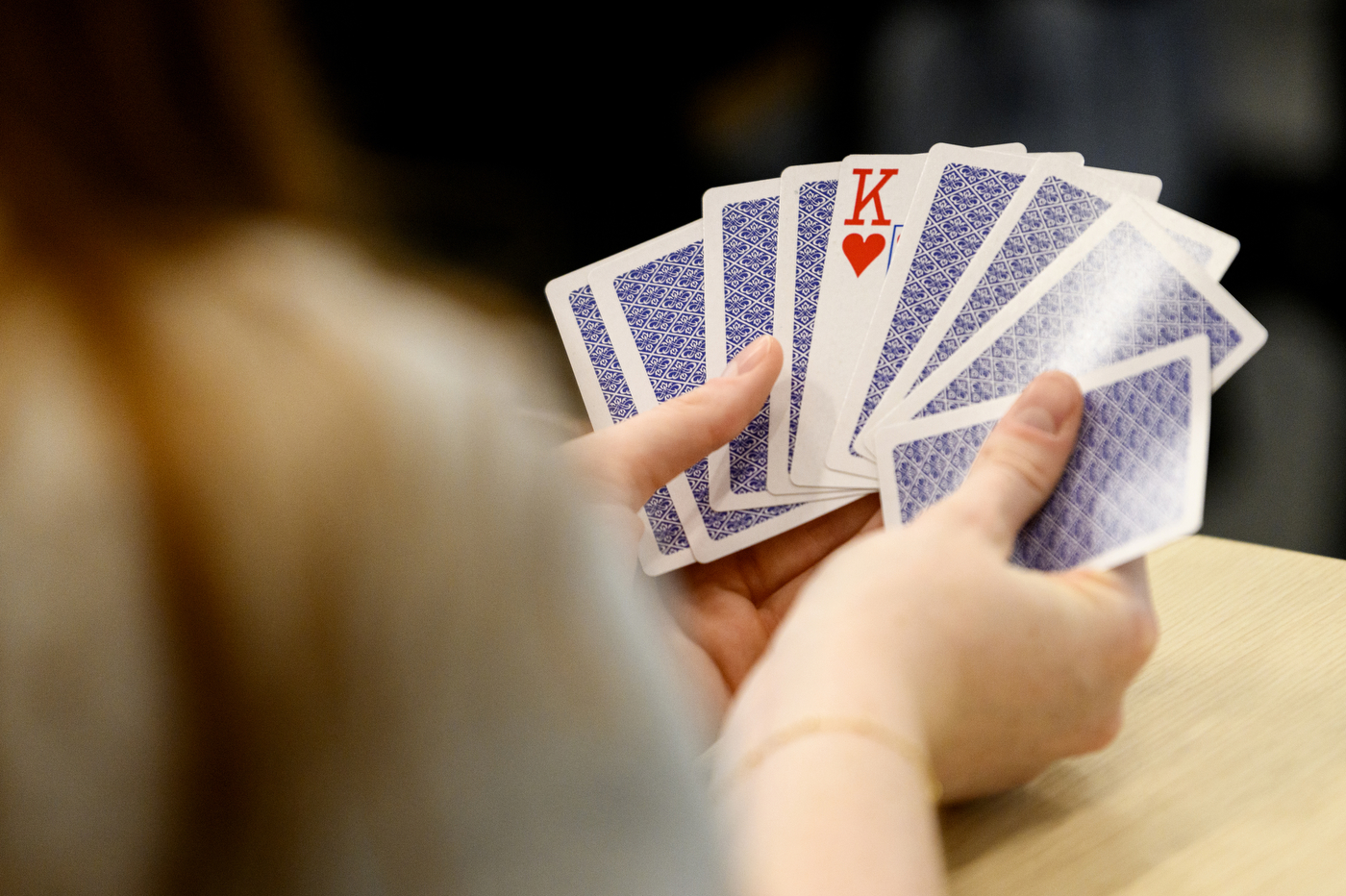 Student holding a stack of cards.