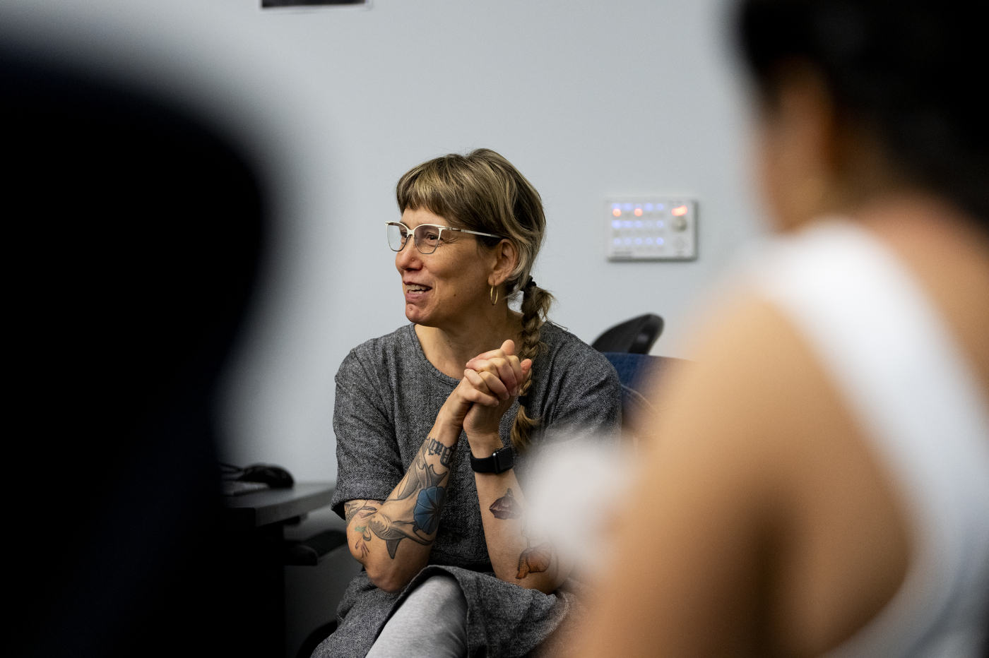 Julia Hechtman sitting in a classroom discussing with her students.