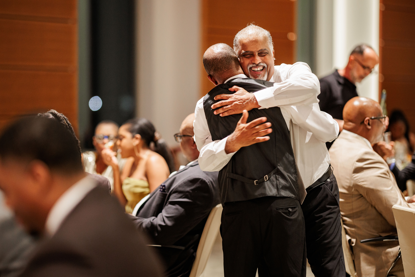 Members of Iota Phi Theta hug each other.