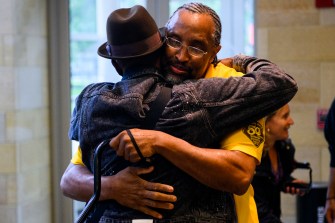 Members of Iota Phi Theta hugging each other.