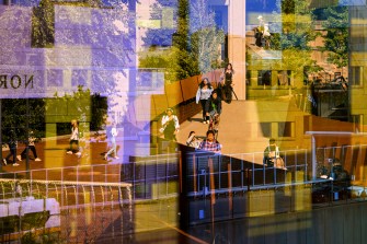 Shot through a camera lens showing various angles, students walk to class on Northeastern's campus.