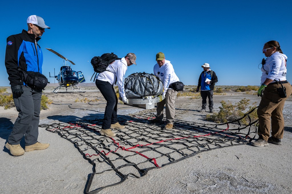 Recovery team members lifting the sample of Asteroid Bennu.