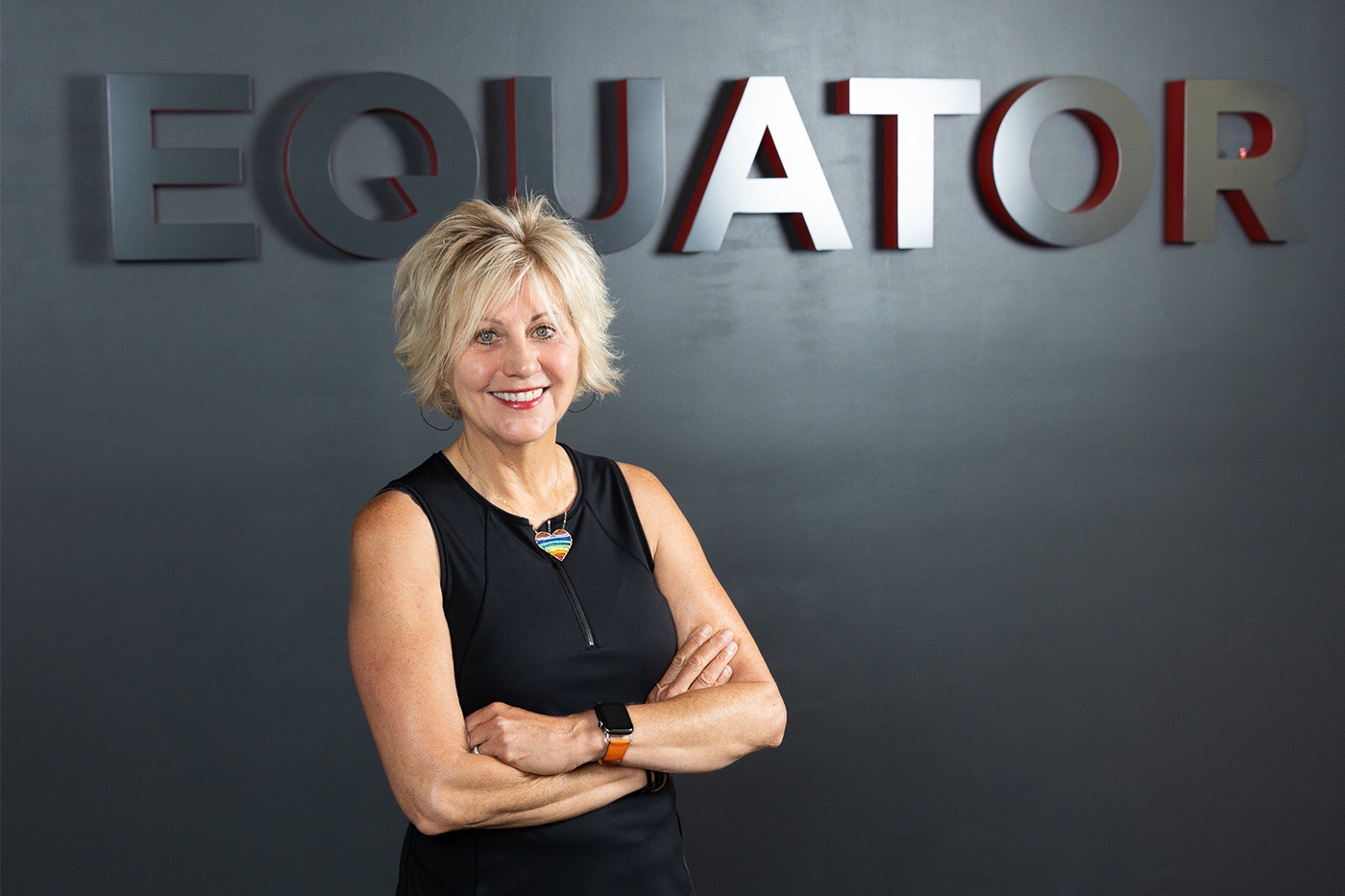 Headshot of Helen Russell in front of an Equator Coffee sign.