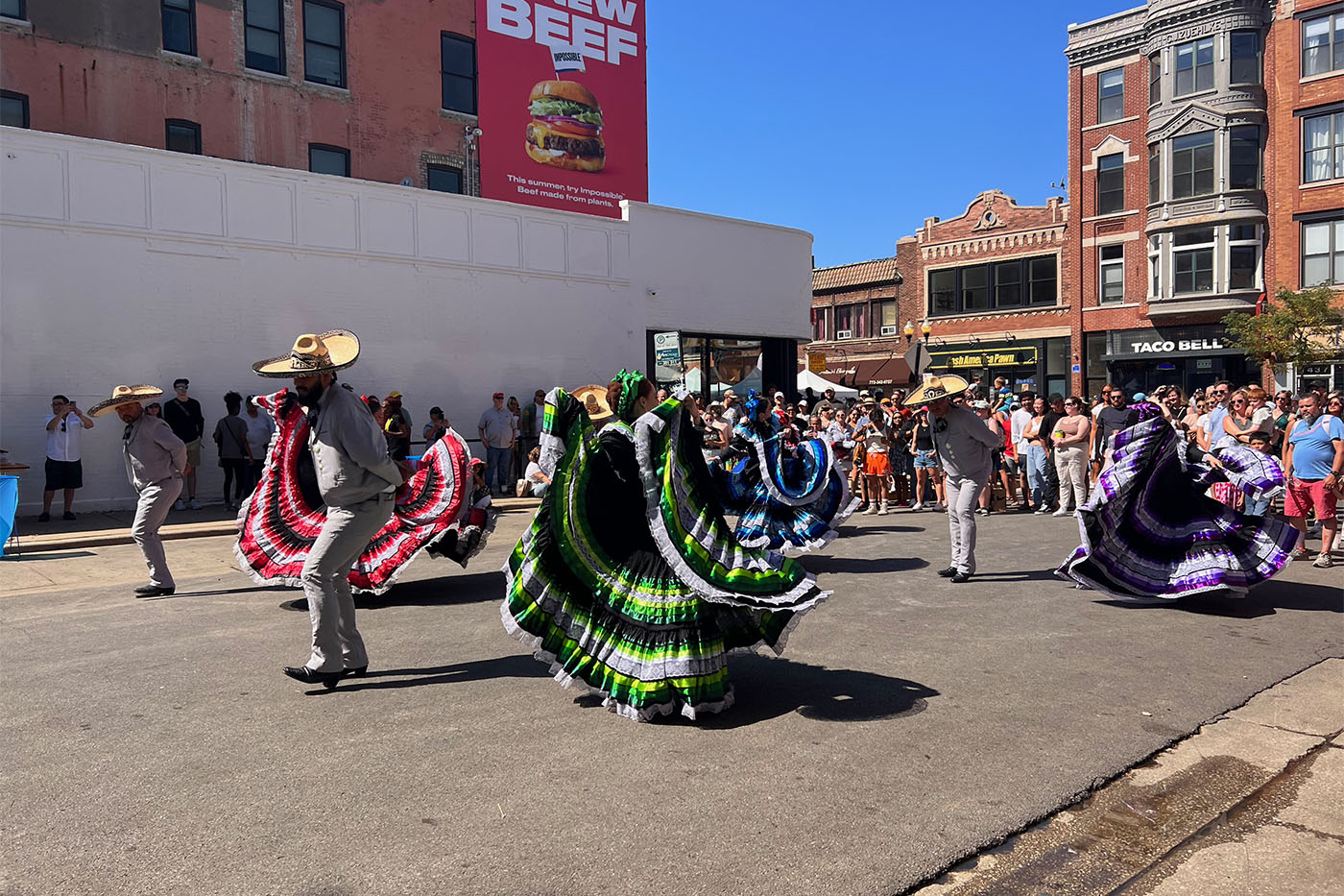 Festival dancers on a street.