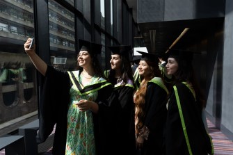 Graduates pose for a picture.